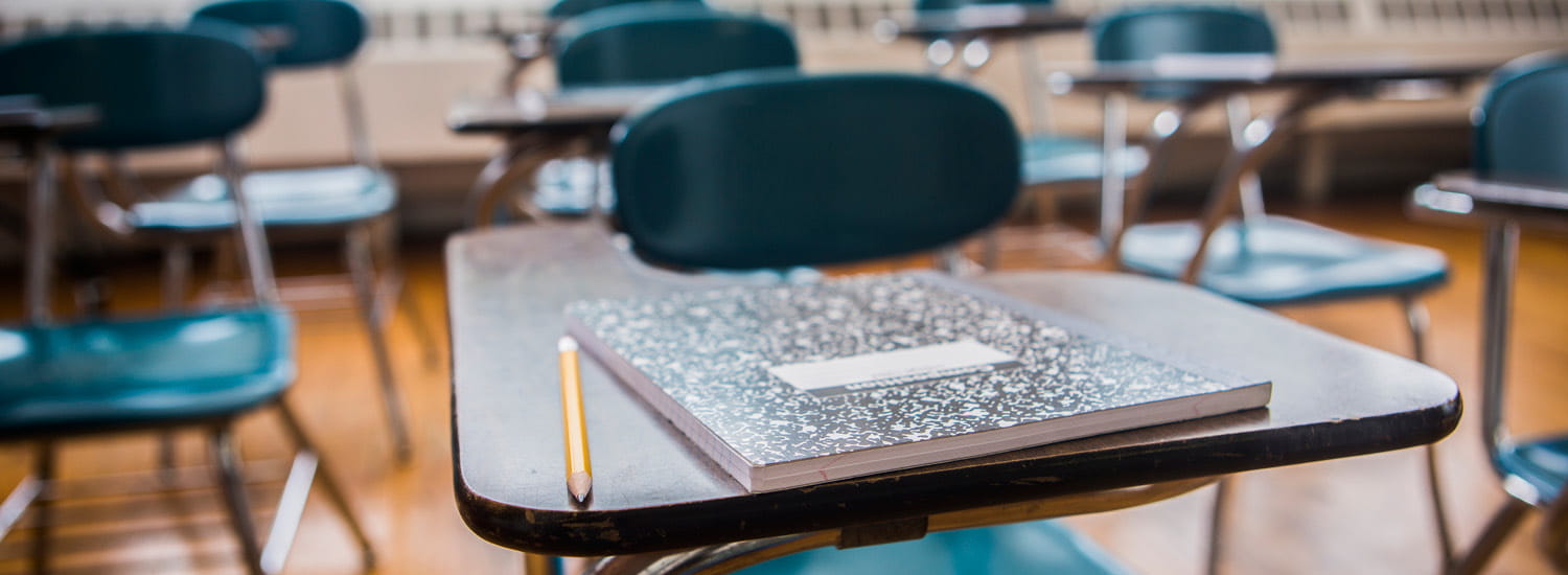 Empty school classroom with desks and chairs